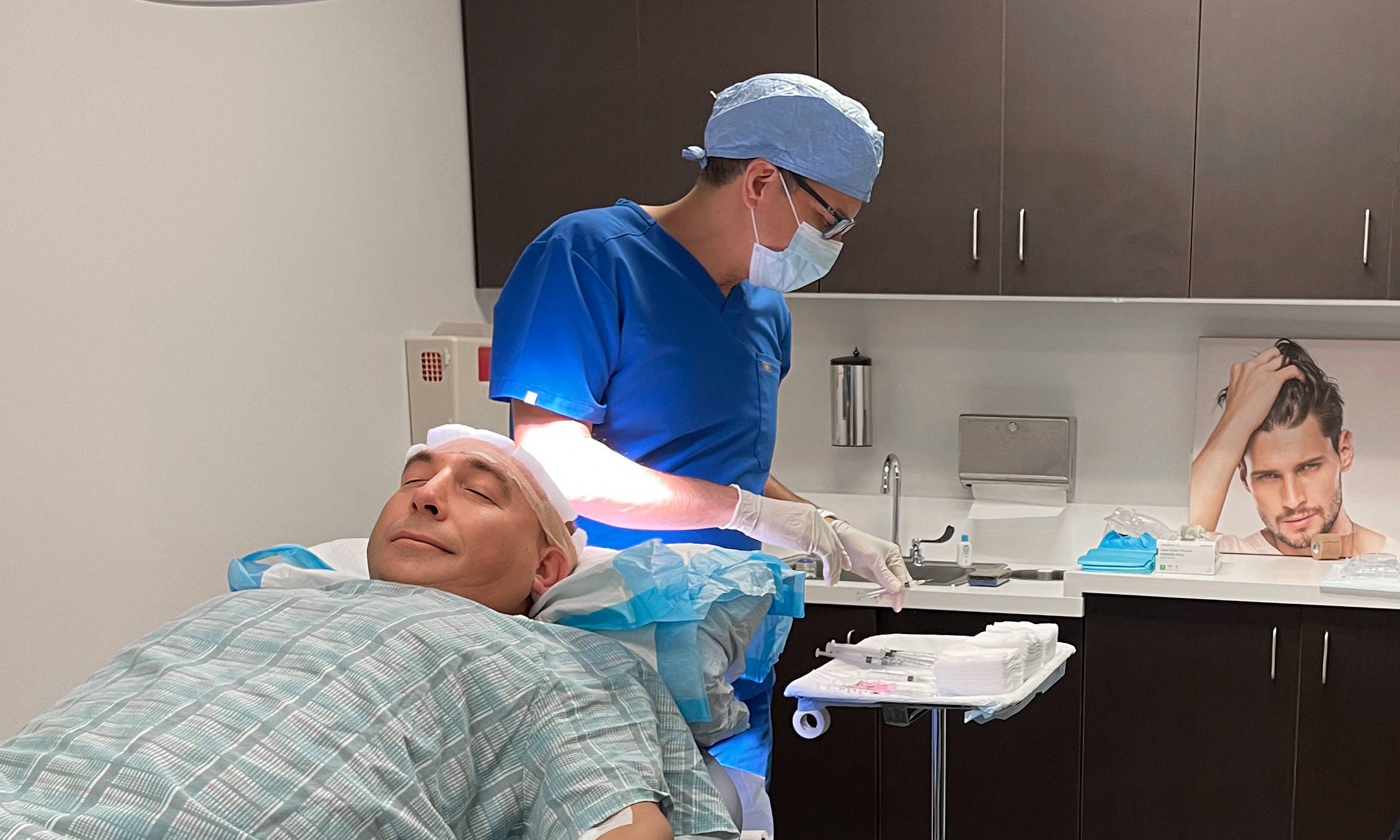 Physician marking where the transplants will be performed on a man suffering from hair loss as a solution for his condition.