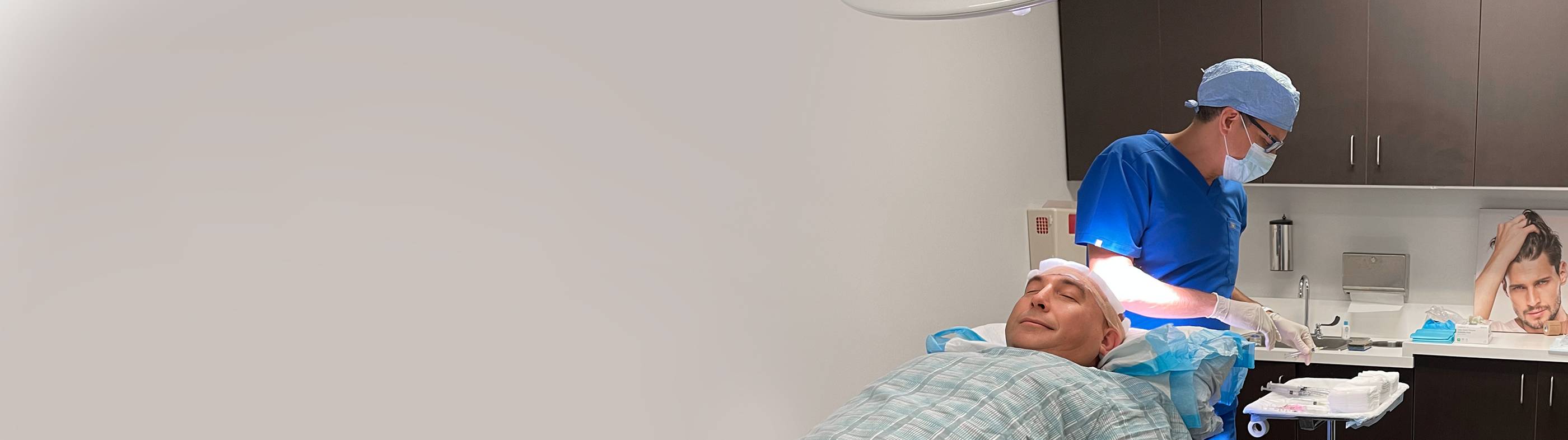 Physician marking where the transplants will be performed on a man suffering from hair loss as a solution for his condition.