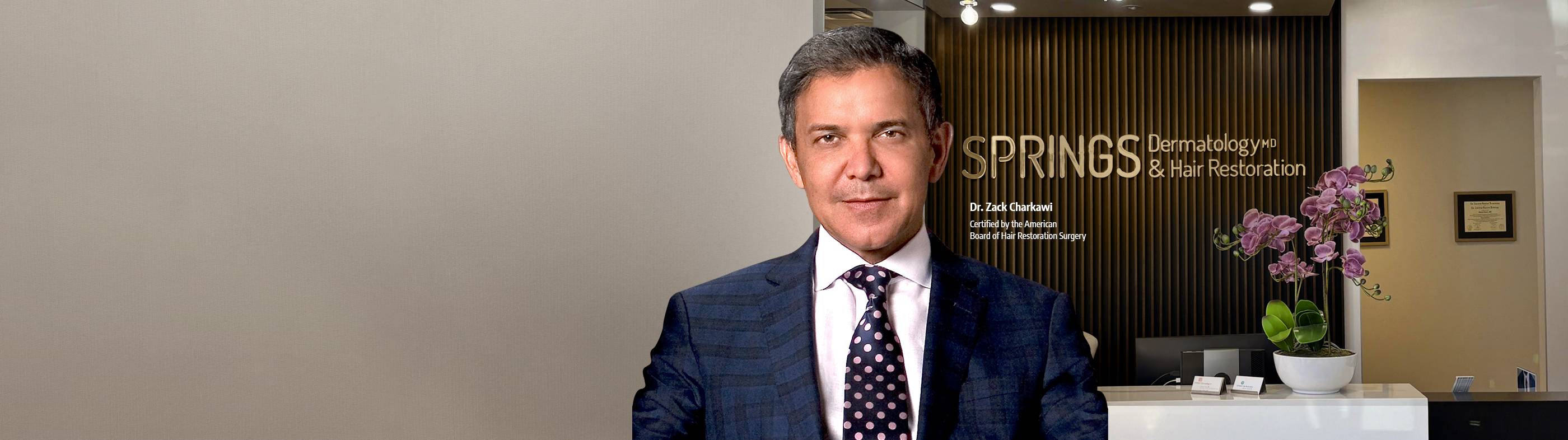 A confident man with a full head of styled, short hair representing successful hair restoration and transplants at Springs Hair Restoration.