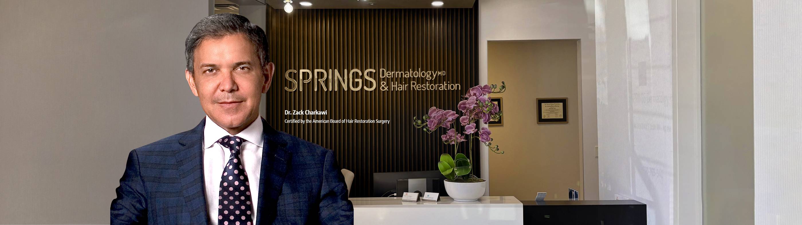 A confident man with a full head of styled, short hair representing successful hair restoration and transplants at Springs Hair Restoration.