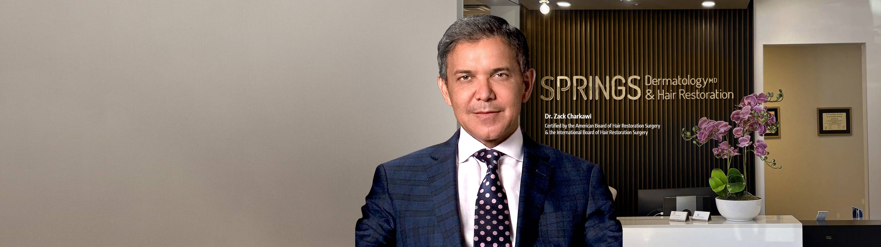 A confident man with a full head of styled, short hair representing successful hair restoration and transplants at Springs Hair Restoration.