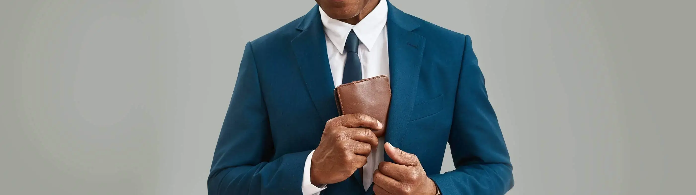 A man is reaching for his wallet to demonstrate financing plan options for a hair transplant.