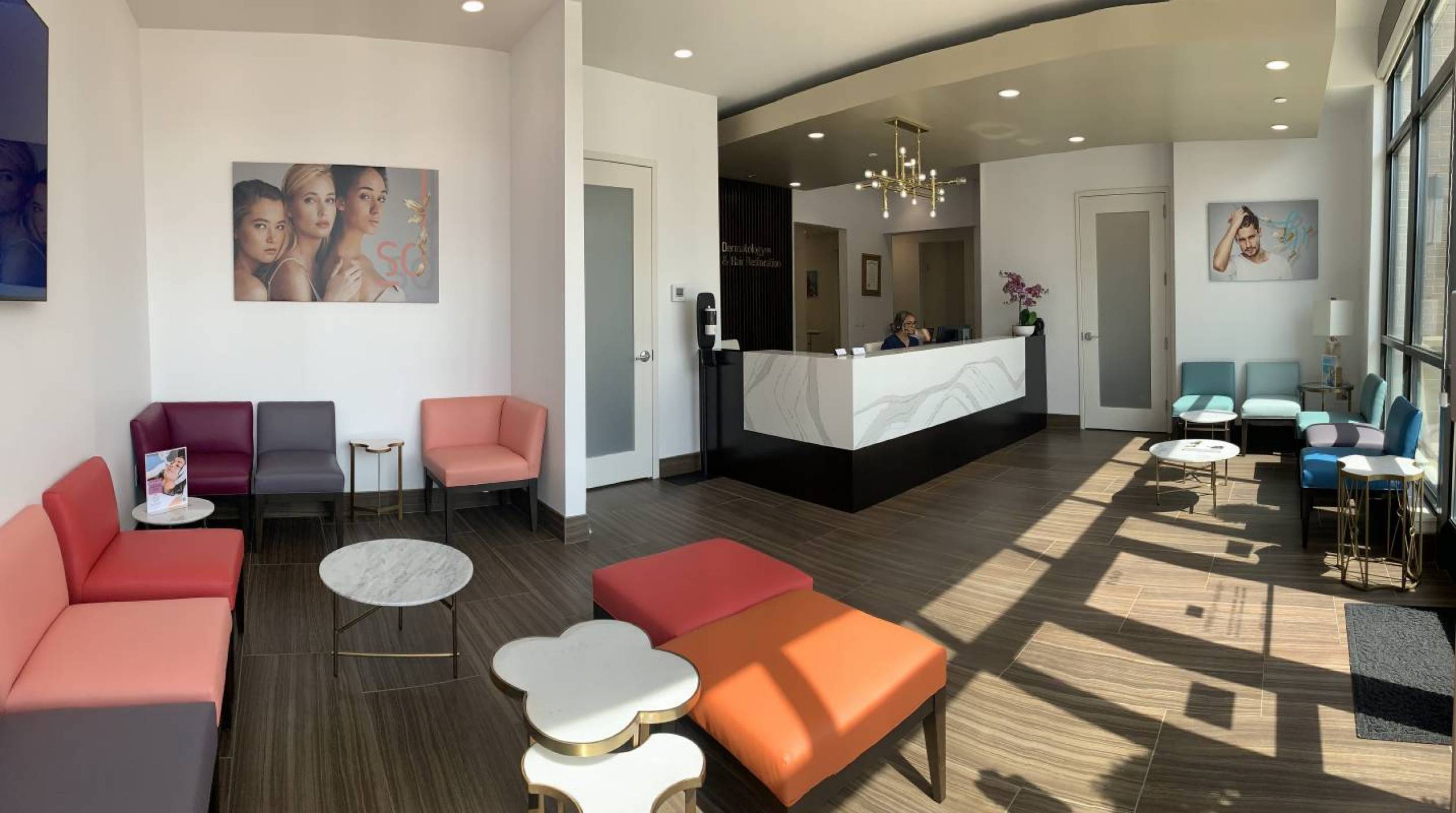 A friendly front desk welcomes patients in the modern, well-lit, and comfortable lobby of the Springs Hair Restoration.