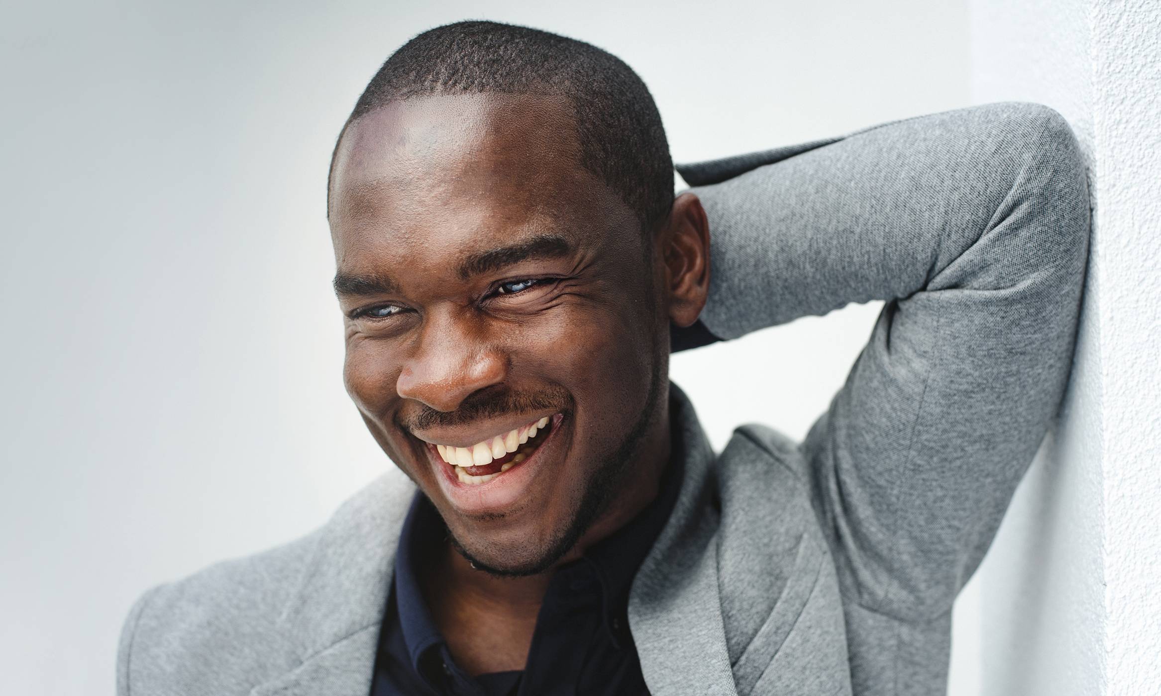 A smiling man with a close-cropped haircut, showcasing the confidence and satisfaction from a successful hair transplant.