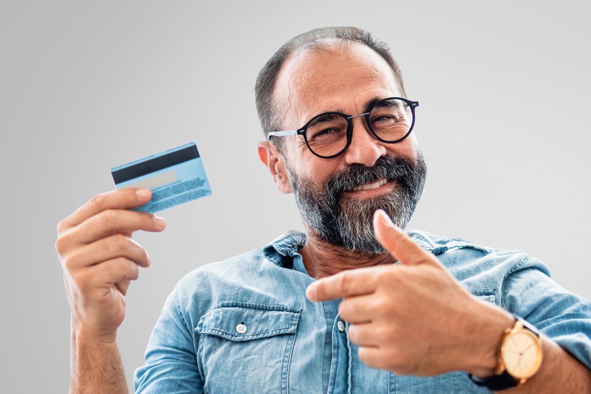 Smiling man with restored hair after affordable hair transplant