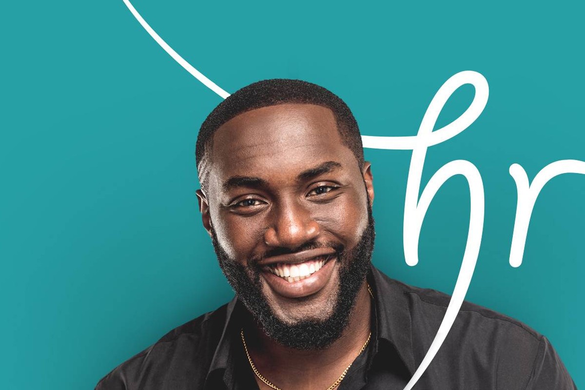 Confident man with thick, natural-looking hair against teal background.