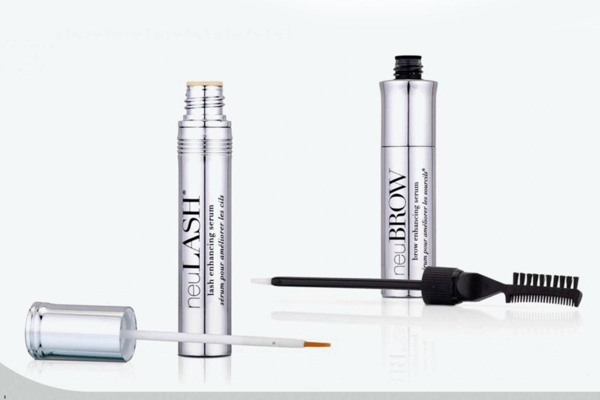 neuLASH and neuBROW serums standing upright, with their applicators placed in front on a light background.